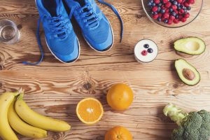 Hardloop schoenen op een tafel met gezond eten en drinken er op.