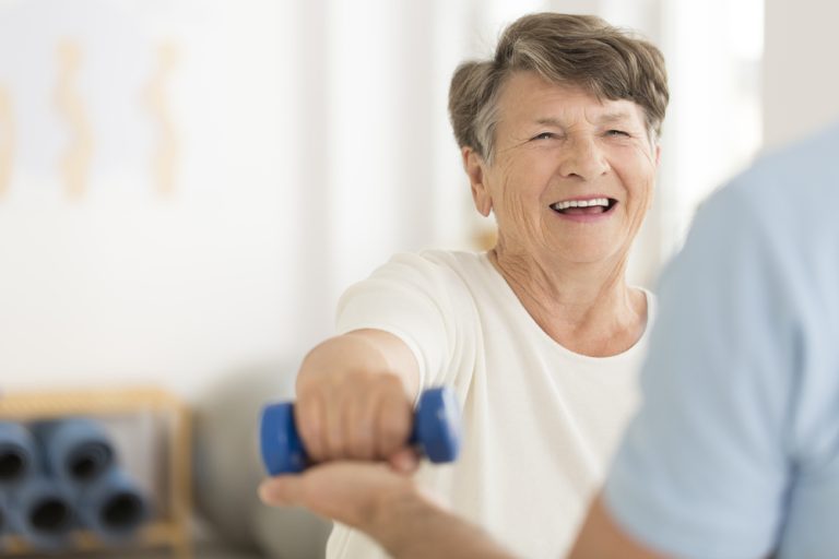 13-06-Fysiotherapeutische communicatie verhoogt zelfrapportage van fysieke activiteit_728819656 Prettige gesprek tussen patiënte en fysiotherapeut tijdens het oefenen.