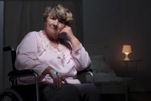 Sombere oudere vrouw in verpleeghuis die liever in haar eigen huis was.