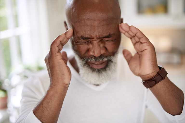 If only this pain would go away Shot of a mature man suffering from a headache at home