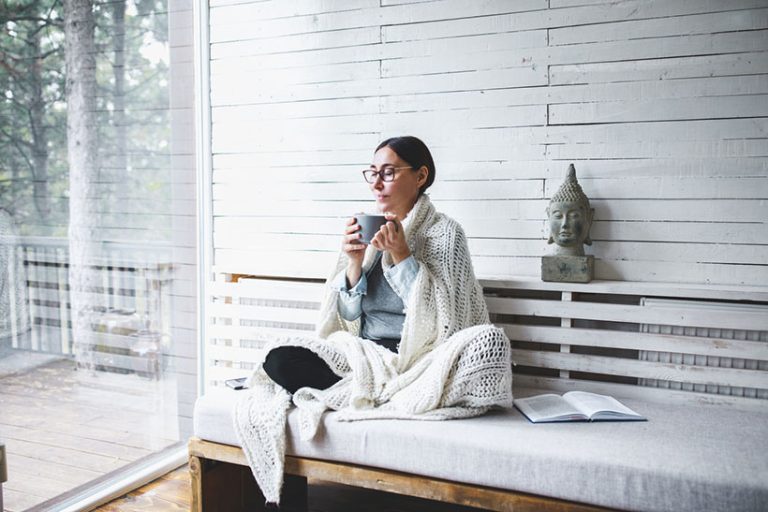 Middle-aged woman siting comfortable and enjoys tea Middle-aged woman siting comfortable and enjoys tea