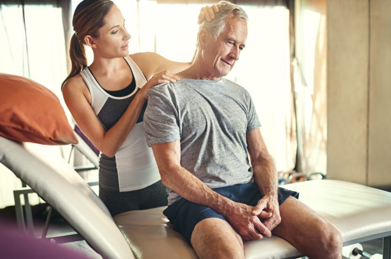 Shot of a senior man being treated by a physiotherapist
