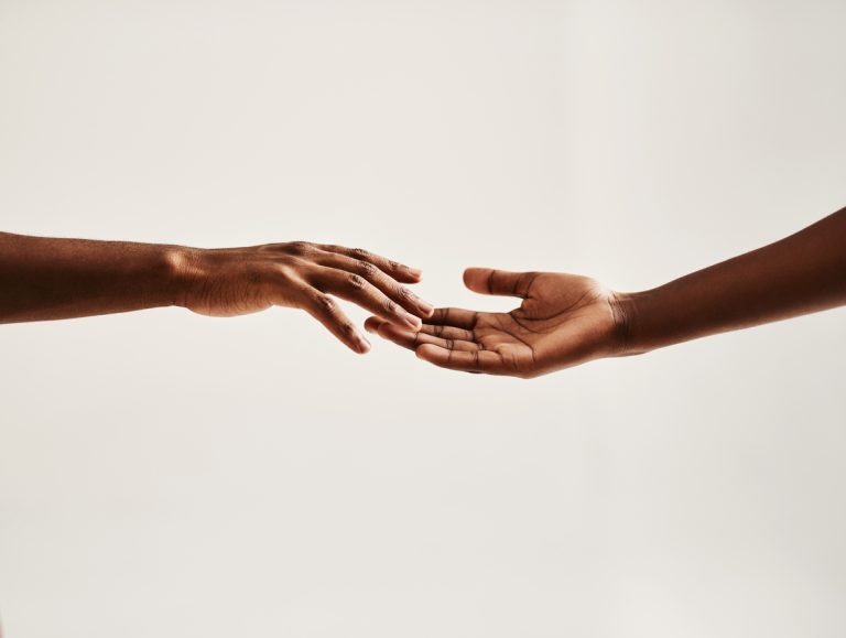 Reach out to someone Closeup shot of two unrecognisable people reaching for each other with their hands