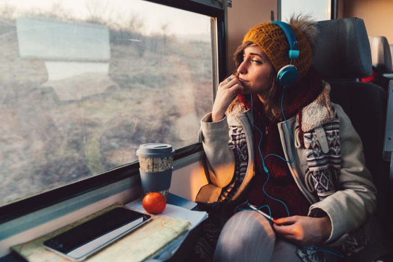 Traveler on a journey with train Thoughtful woman in the train looking through the window