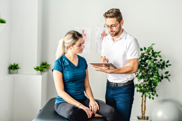 A A Modern rehabilitation physiotherapy man at work with woman client