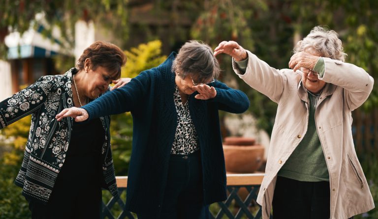 Keeping up with trends Cropped shot of a group of senior woman standing together and dabbing during a tea party outdoors