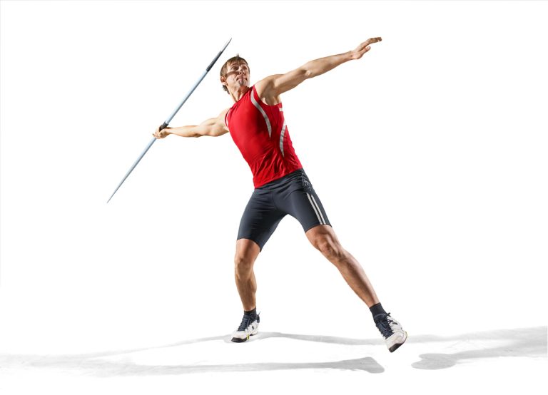 Javelin thrower A young male athlete with a javelin isolated on a white background