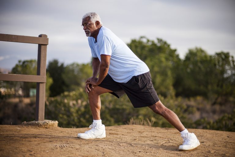 Senior Black Man Stretching and Exercising Outdoors An attractive senior black man exercises outdoors with various muscle stretches