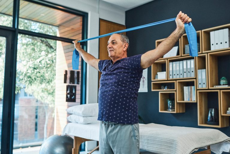 Don’t let your inner superhero fade away Shot of a senior man using a resistance band during a physiotherapy session