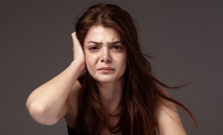 Freckled beautiful young woman crying. Freckled beautiful young woman crying.