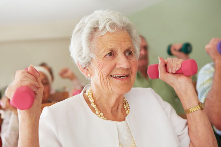 Strong and young at heart An elderly lady lifting light weights to strengthen her arm muscles