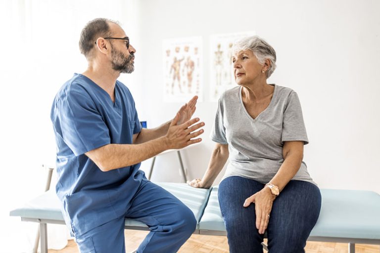 Doctor’s do it for the health of it Cropped shot of a handsome mature male physiotherapist doing a consultation and assessment with a senior female patient.