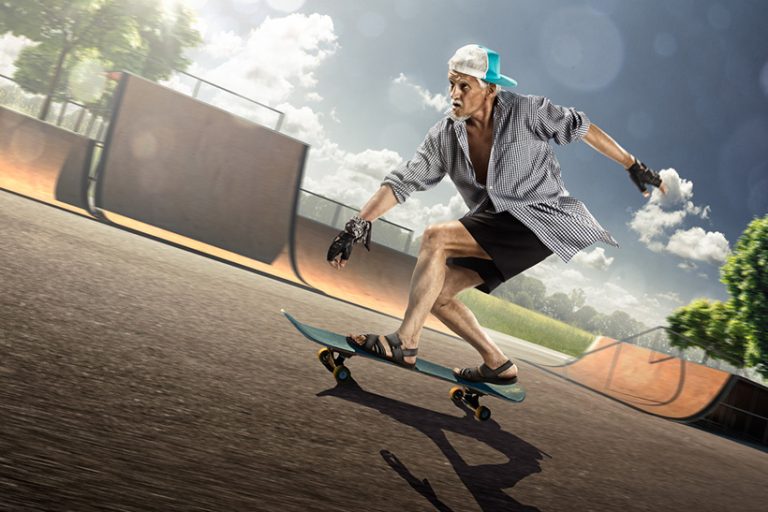 The old man is skating on skateboard The old man is skating on skateboard in skate park