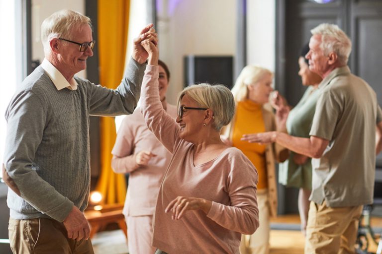 Group Group of smiling senior people dancing while enjoying activities in retirement home