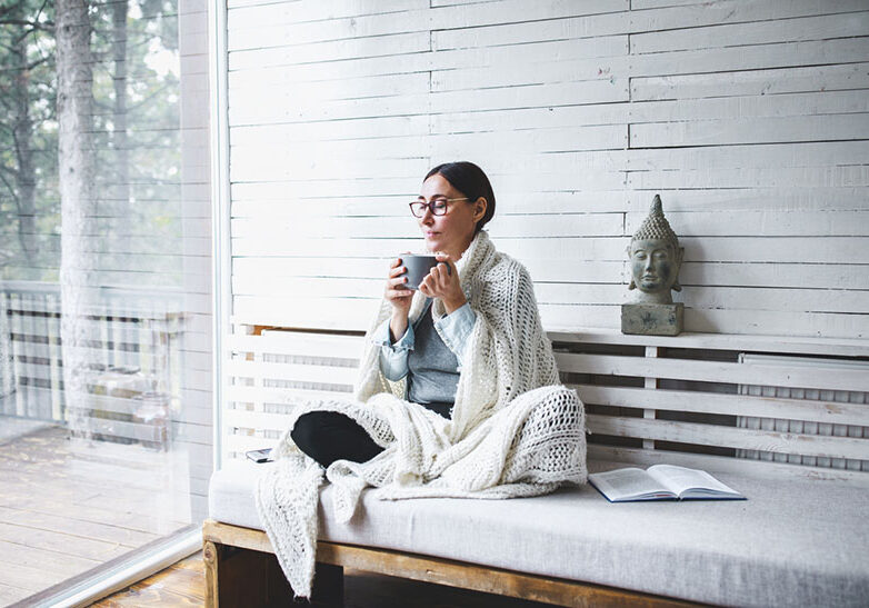 Middle-aged woman siting comfortable and enjoys tea