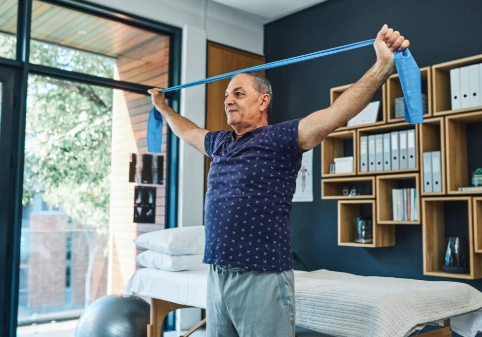 Shot of a senior man using a resistance band during a physiotherapy session