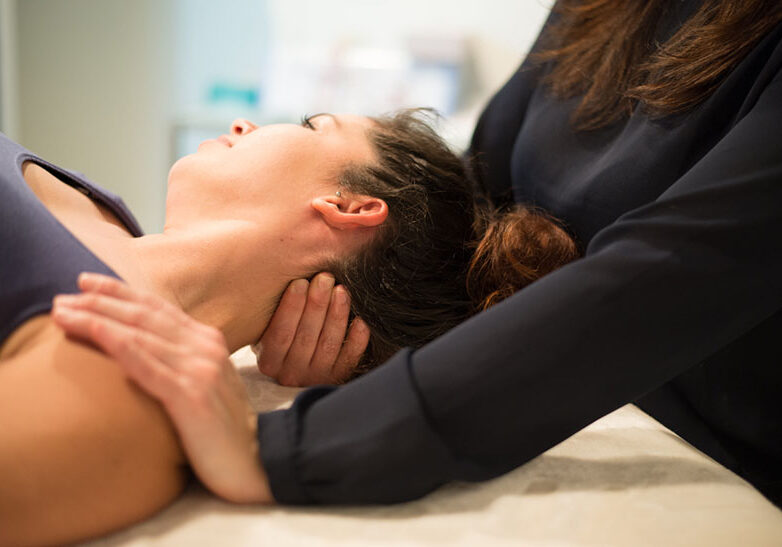 Physical Therapist stretching patients neck